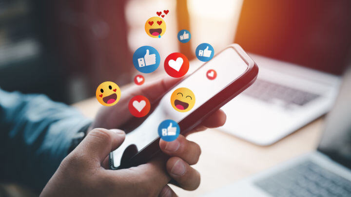 smartphone with likes and hearts coming out of it