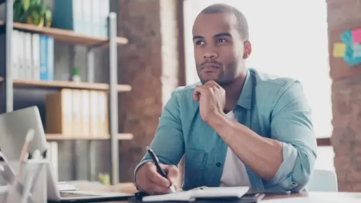 man thinking at desk