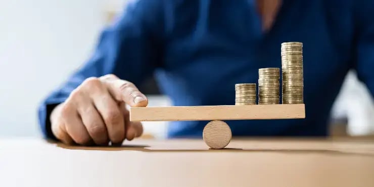 man balancing coins on scale