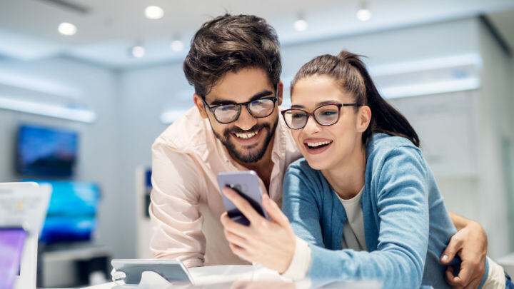 man and woman shopping for phones